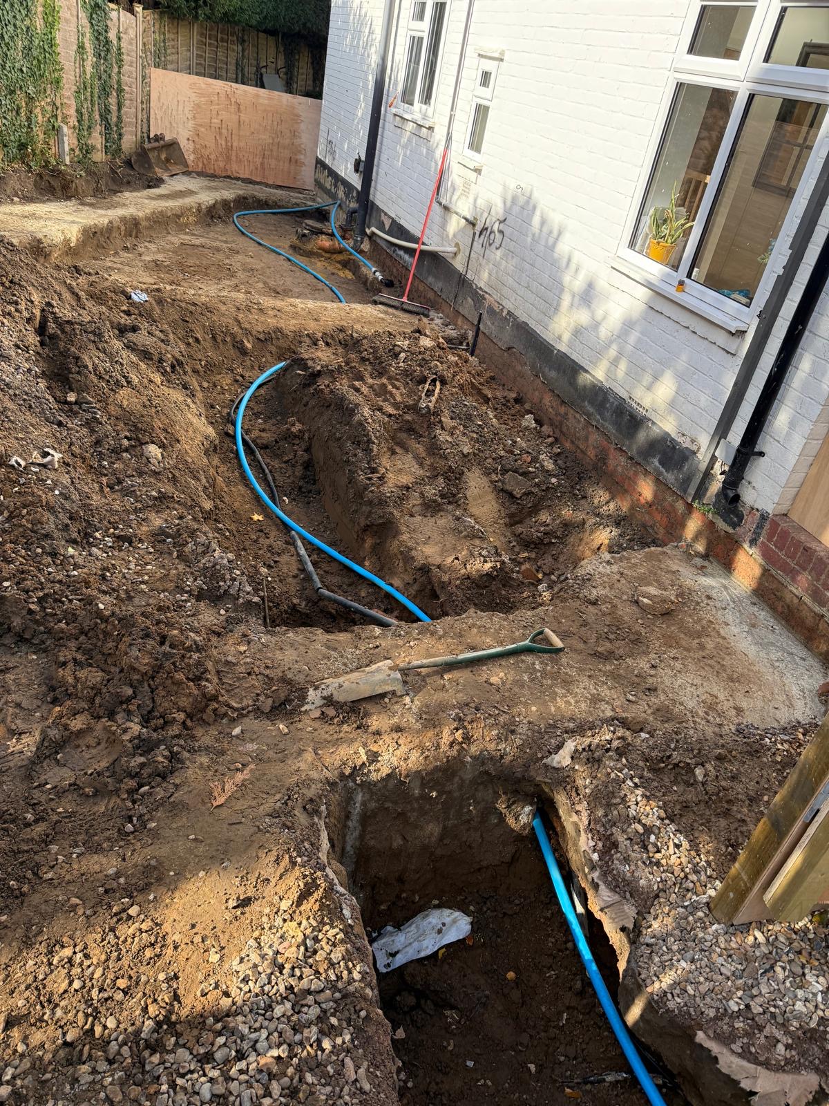 Moling project 1 — access pit excavation with new MDPE blue pipe