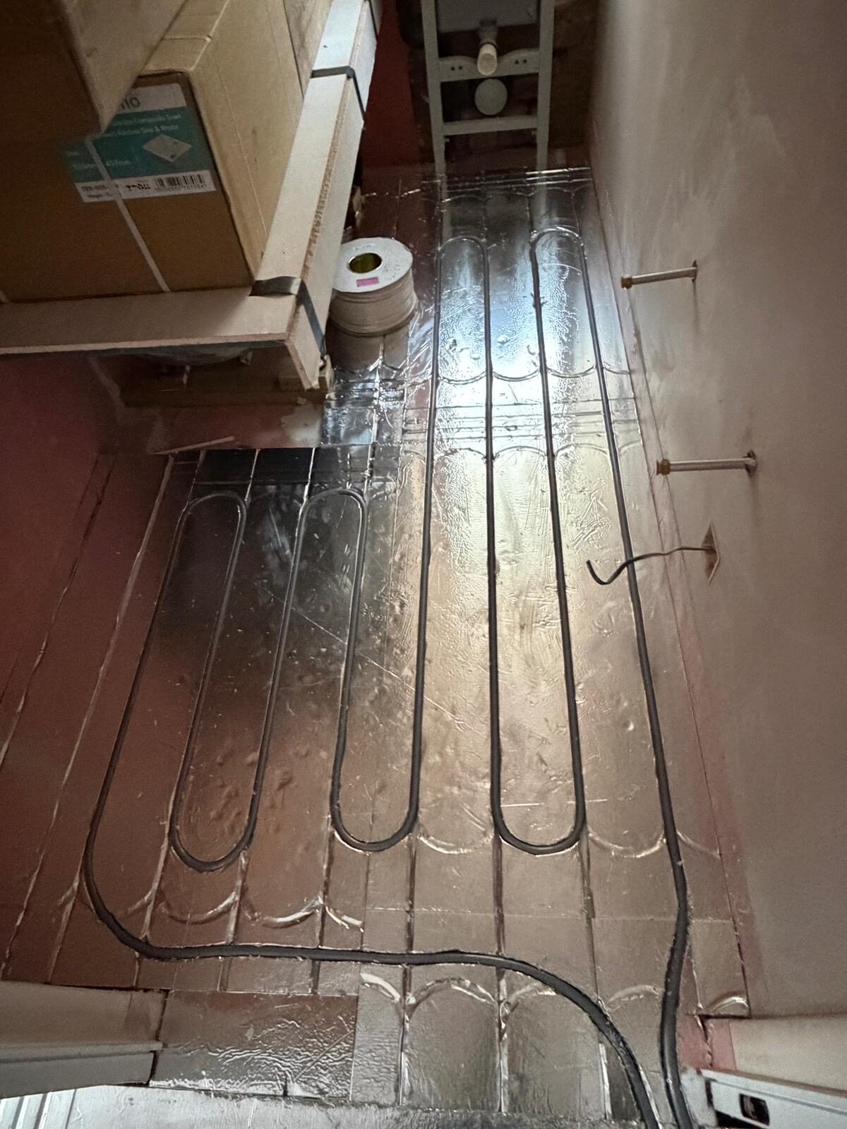 Low-profile foil underfloor heating system fitted in a London bathroom retrofit by Meridian Plumbing