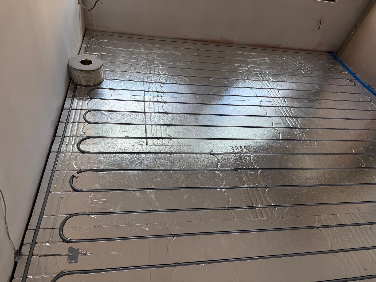 Low-profile foil underfloor heating system installed in a London home by Meridian Plumbing