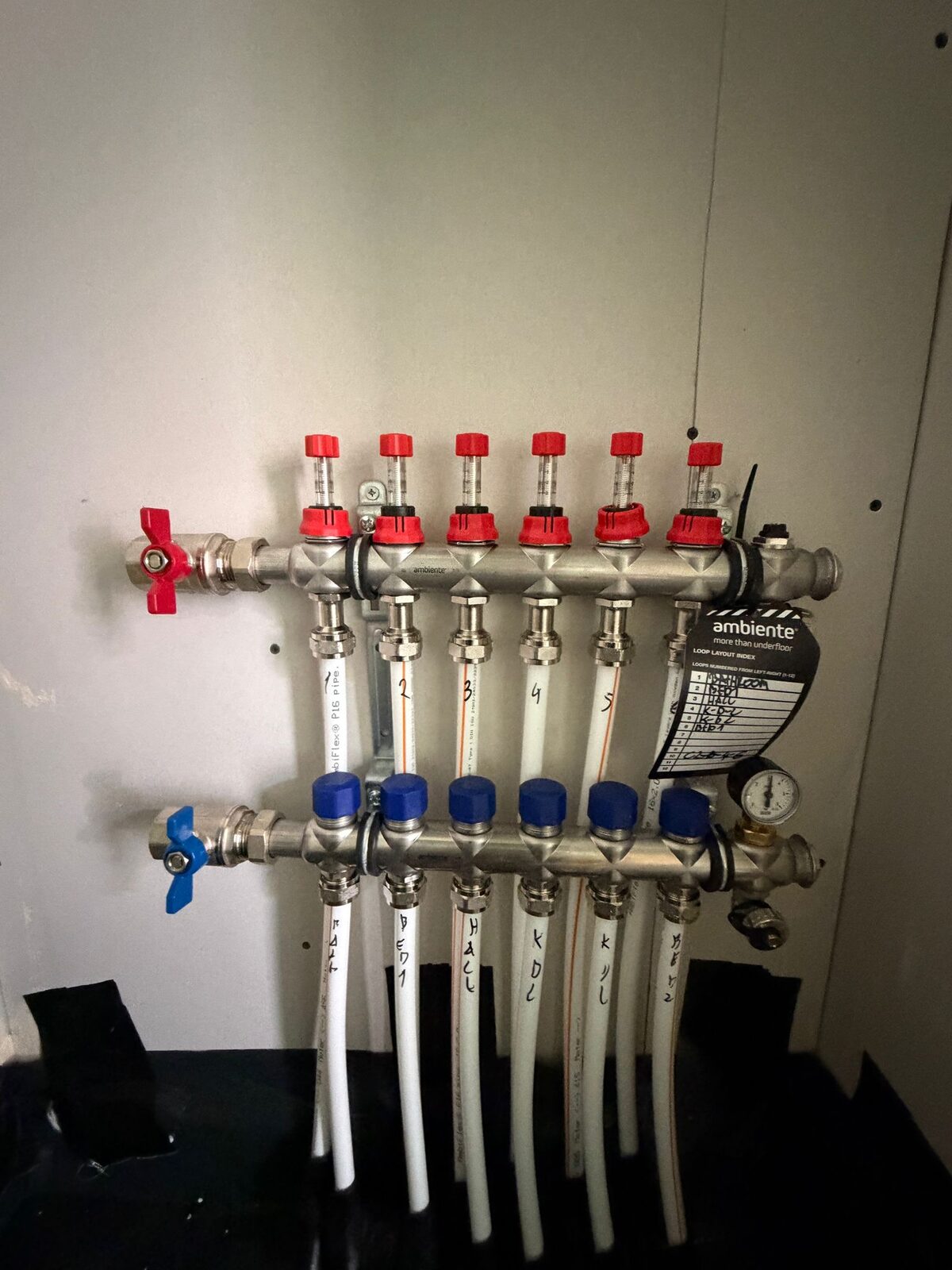 Stainless steel underfloor heating manifold installed by Meridian Plumbing