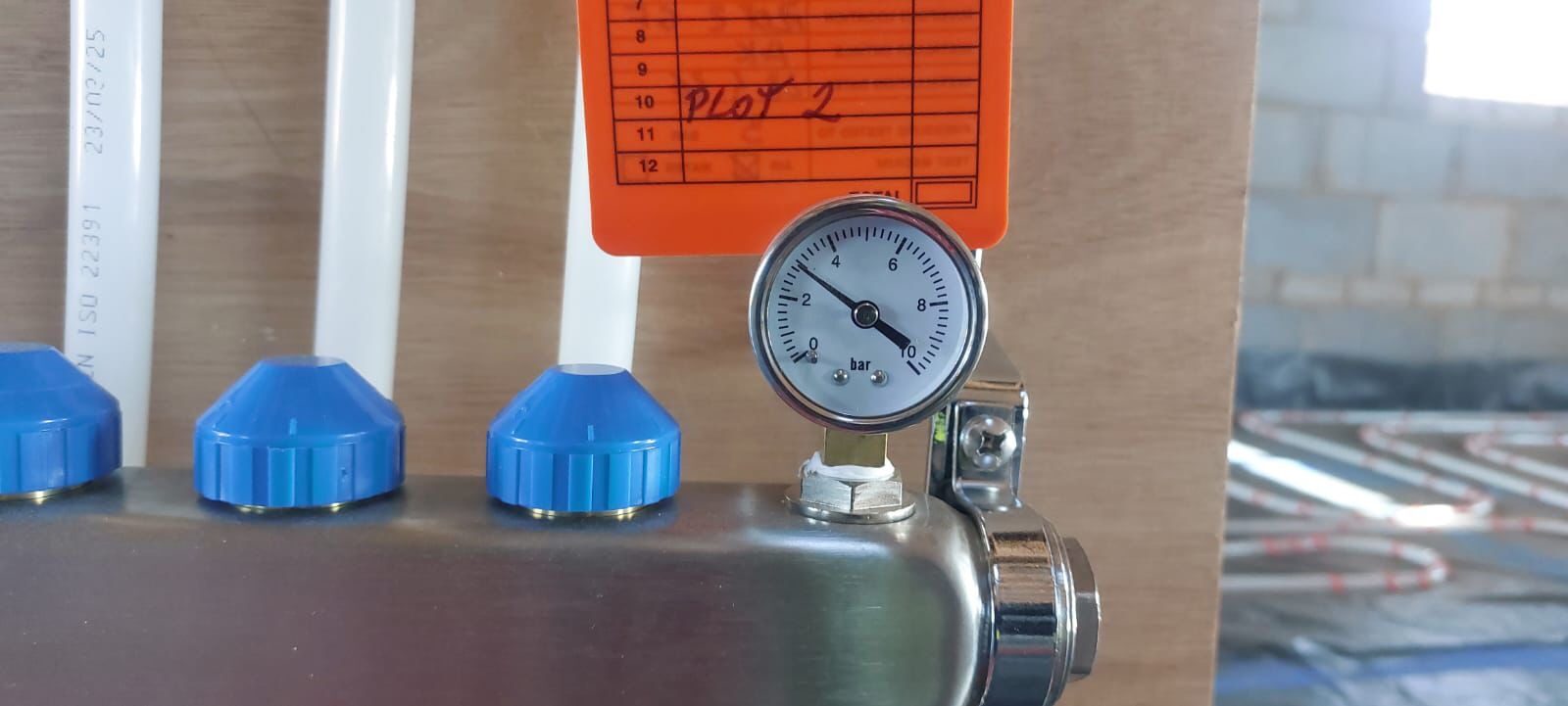 Pressure testing a retrofit wet underfloor heating system before the floor finish is laid in a London property